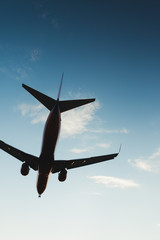 Underneath Airplane with pretty blue sky in background
