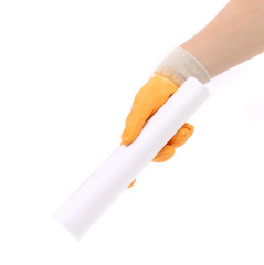 Man hand in yellow glove holding paper roll.