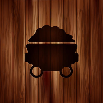 Mining coal cart icon.Wooden background