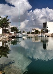 sailing boats reflected in water canal