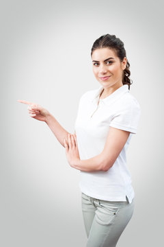 Portrait of young woman worker pointing above