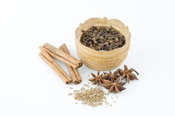 Spices per pod and scattered on the table beside.