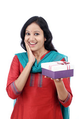 Surprised young woman with gift box