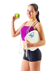 Sporty girl with apple and scales