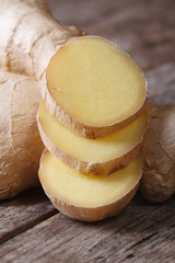 Sliced ​​ginger root rings close-up on the table. vertical