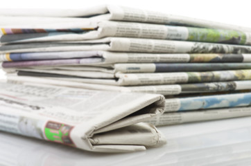 Pile of Various newspapers over white background - 63971098
