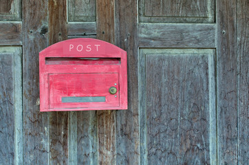 Red wooden mail box on wooden wall