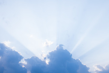 sunset burning blue sky with white big cloud and sunrise ray