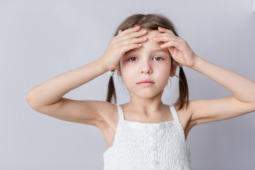 Portrait of preschooler girl having a headache