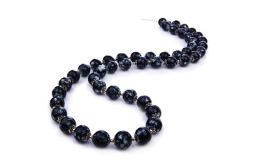 Dark pearl necklace isolated on the white