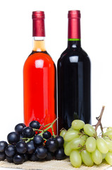 Bootles of wine with black and white grapes