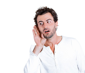 Portrait Curious man, hand to ear, listening to latest rumors