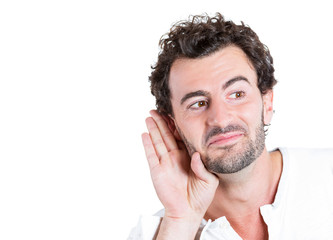 Portrait Curious man, hand to ear, listening to latest rumors