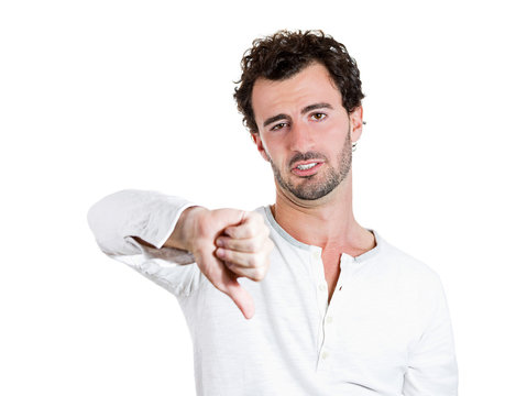 Grumpy middle aged man showing thumbs down gesture 