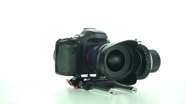 DSLR camera rotates on a white background