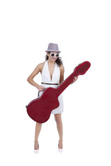 Smiling young female wearing sunglasses posing with guitar
