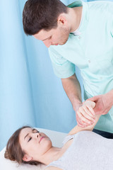 Obraz na płótnie Canvas Physiotherapist examining arm