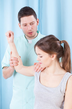 Therapist streaching woman's arm