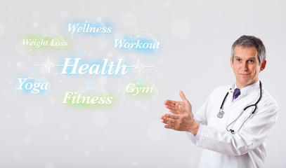 Clinical doctor pointing to health and fitness collection of wor