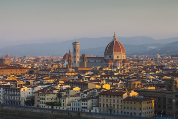 Fototapeta na wymiar Golden sunrise over Palazzo Vecchio and Cathedral of Santa Maria
