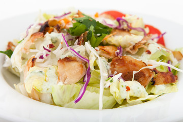 Chicken salad with tomatoes, arugula in the white bowl