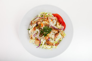 Chicken salad with tomatoes, arugula in the white bowl