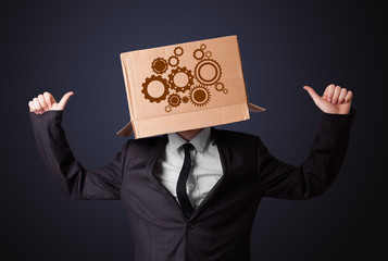 Young man gesturing with a cardboard box on his head with spur w