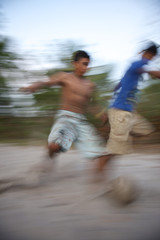 Fototapeta na wymiar Football Soccer Players Game Running Blur Sand Pitch