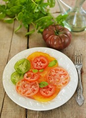 Tomato salad on wooden background
