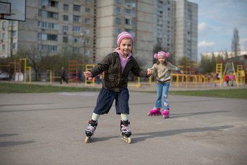 Young girl riding on roller skates.