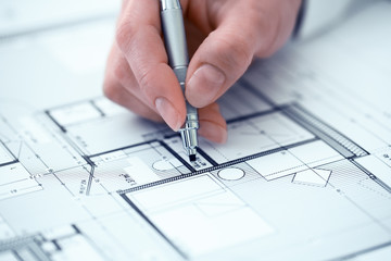 Woman Architect drawing on print  construction project