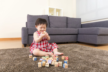 Asia little girl play wooden toy block