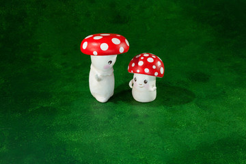 cute puppets handmade, two mushrooms, green background