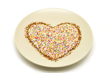 Dish with a heart formed by balls anis and cinnamon
