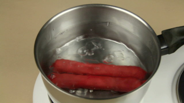 Frankfurters put in a pot of boiling water