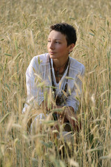 Naklejka na ściany i meble Young girl on wheat field