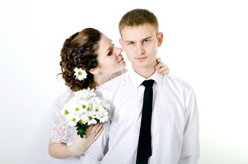 serious groom and happy bride on a white