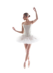 Elegant young ballerina isolated on white backdrop