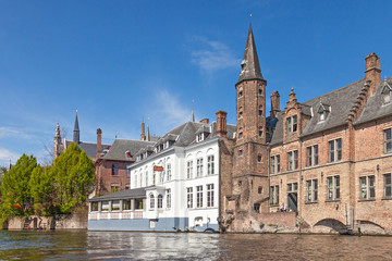 Ancient red brick building with little tower in Bruges