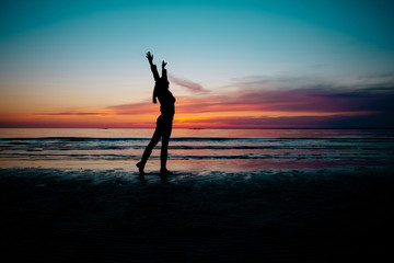 Fototapeta na wymiar Silhouette of Woman on the Sunset