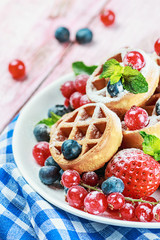 Waffles with fresh berries on the table