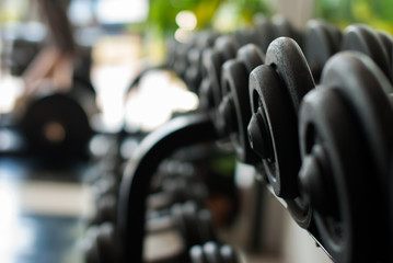 Obraz na płótnie Canvas Row of Hand Barbells weight training equipment in gym room