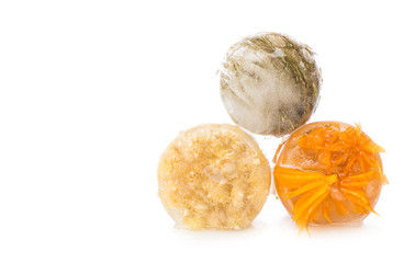 Dried flowers in ice on white background.