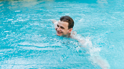 Young man swimming in pool