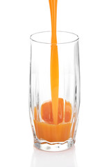 Juice pouring into glass isolated on white