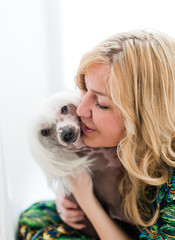 Woman keeping Chinese crested dog