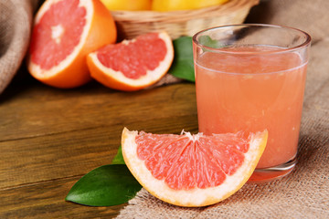 Fototapeta na wymiar Ripe grapefruit with juice on table close-up