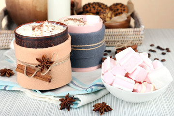 Mug of hot drink decorated in felt on wooden table