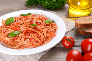Pasta with tomato sauce on plate on table close-up
