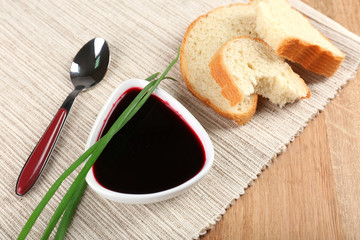 Bowl of beet soup on wooden table